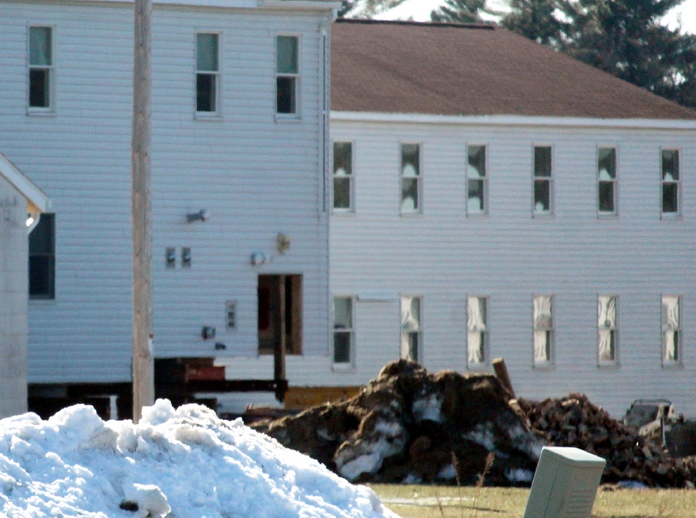 Contractors prepare World War II-era barracks buildings to be moved at Fort McCoy