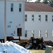 Contractors prepare World War II-era barracks buildings to be moved at Fort McCoy