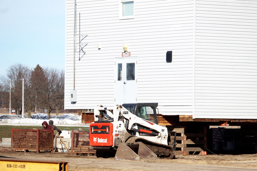 Contractors prepare World War II-era barracks buildings to be moved at Fort McCoy