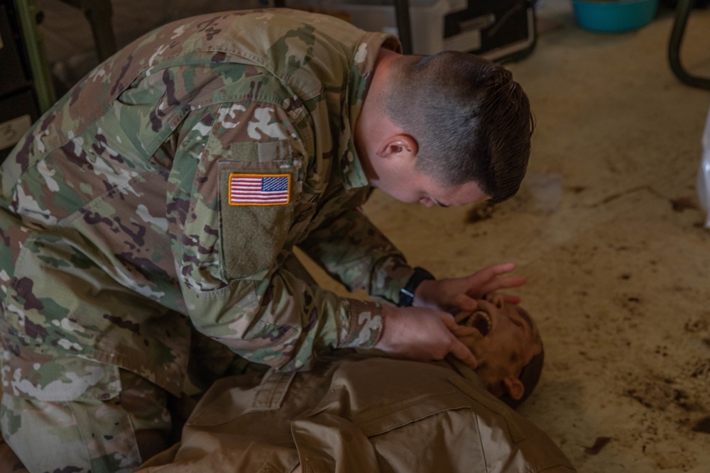 Sgt. Denzel Torres assesses the airway of his patient