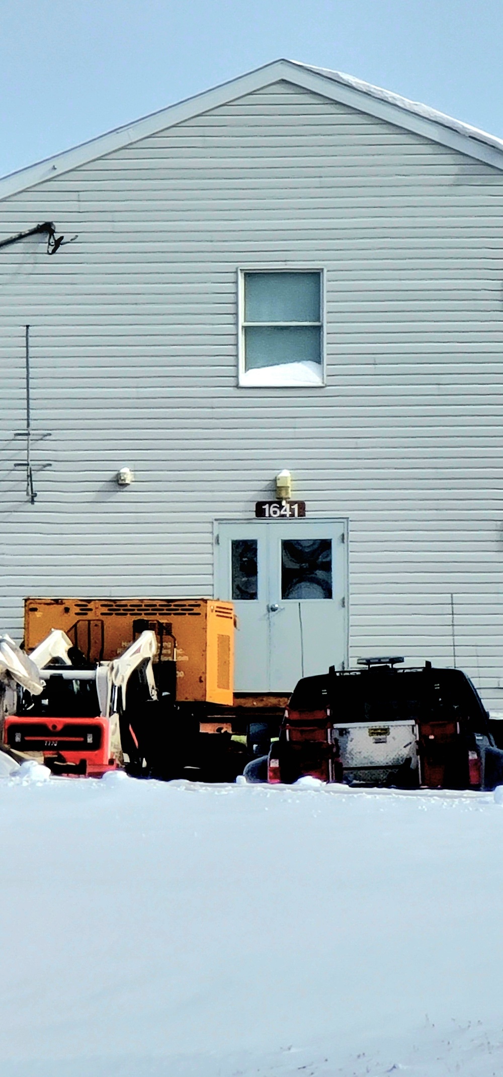 Contractors prepare World War II-era barracks buildings to be moved at Fort McCoy