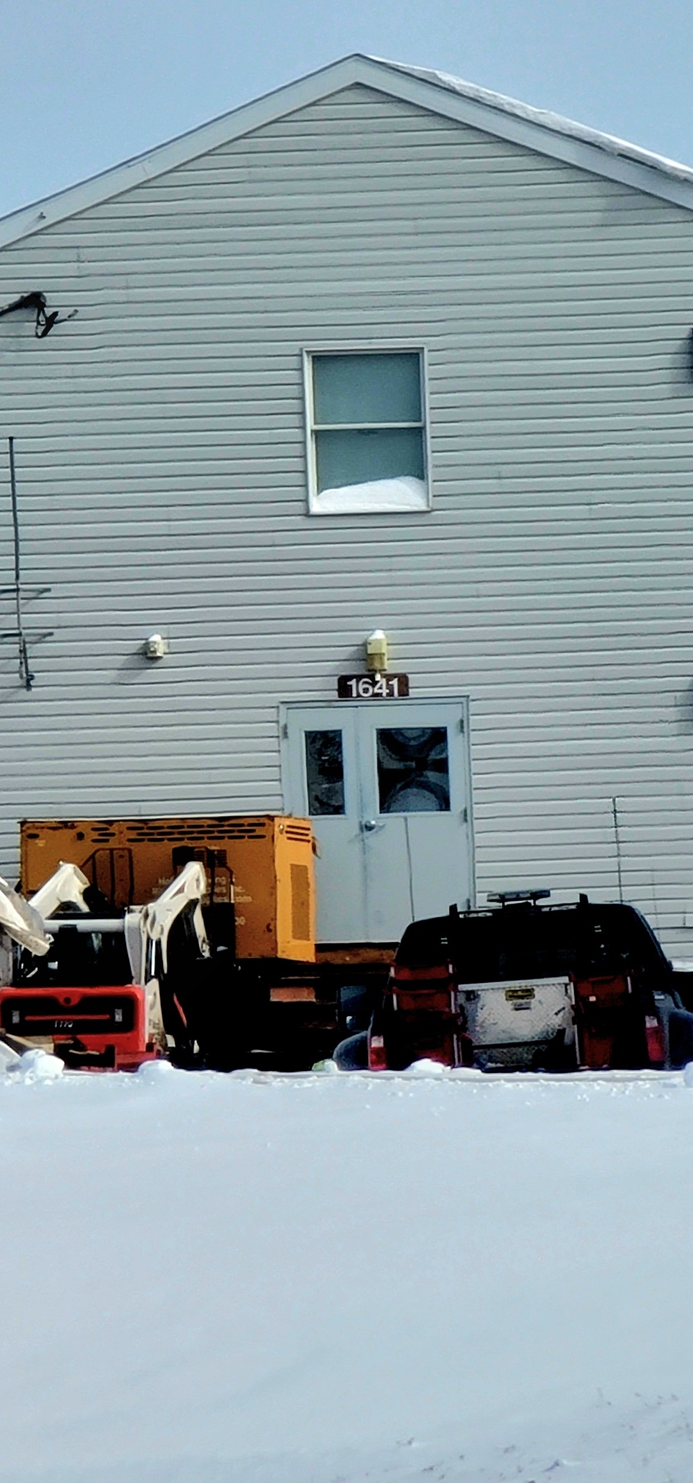 Contractors prepare World War II-era barracks buildings to be moved at Fort McCoy