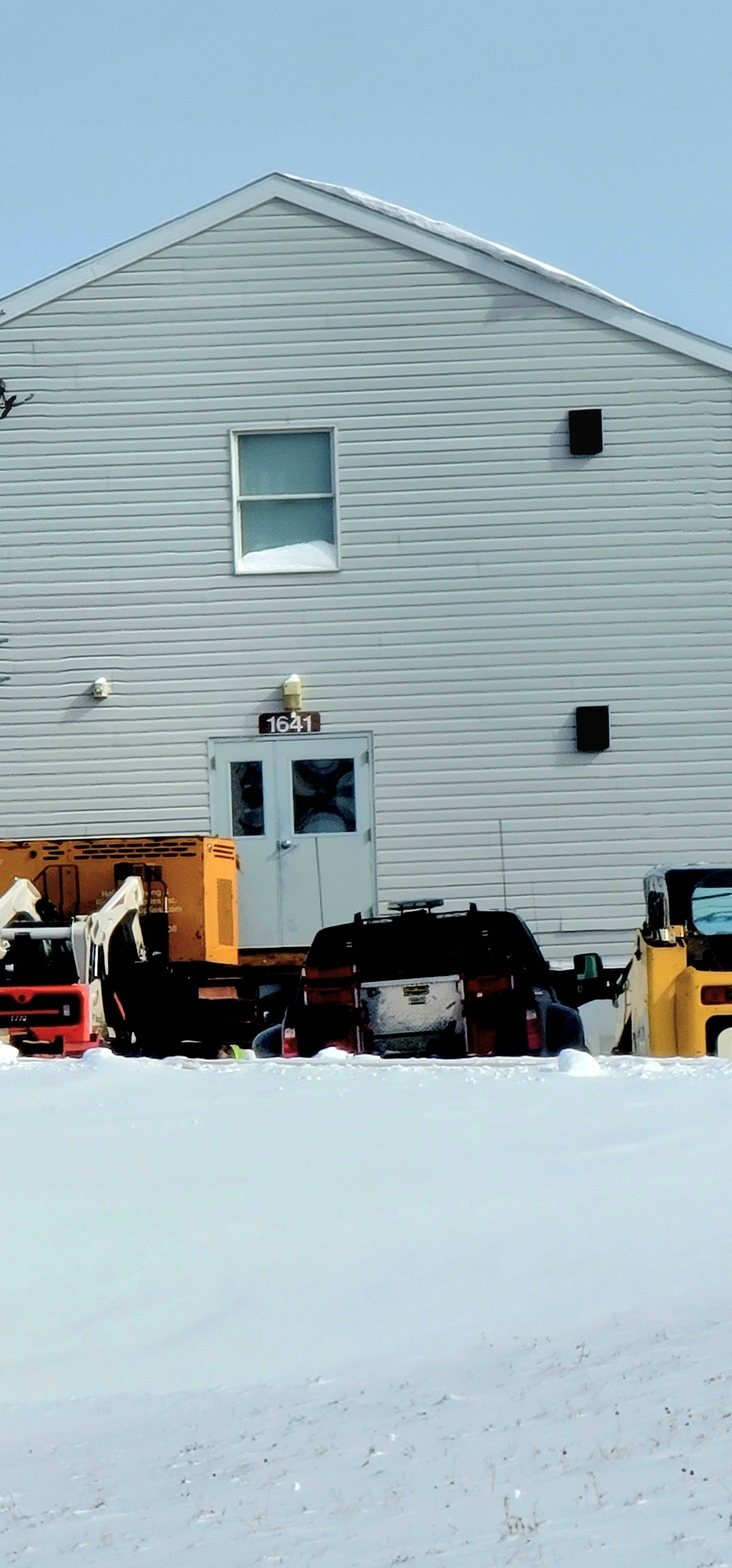 Contractors prepare World War II-era barracks buildings to be moved at Fort McCoy