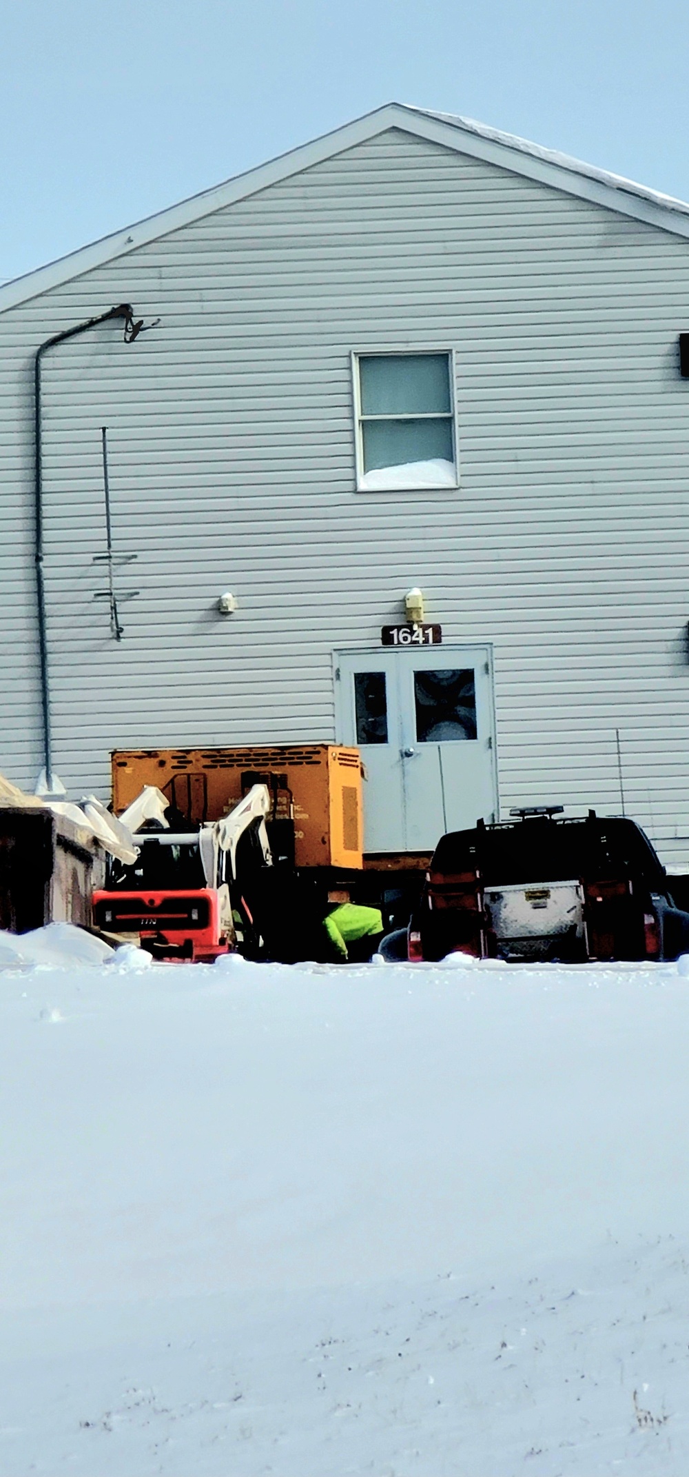 Contractors prepare World War II-era barracks buildings to be moved at Fort McCoy