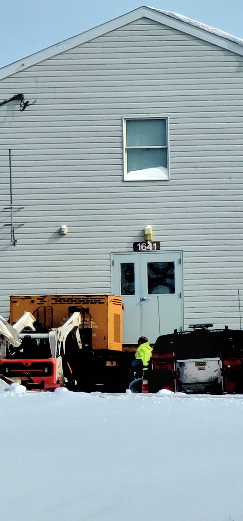 Contractors prepare World War II-era barracks buildings to be moved at Fort McCoy