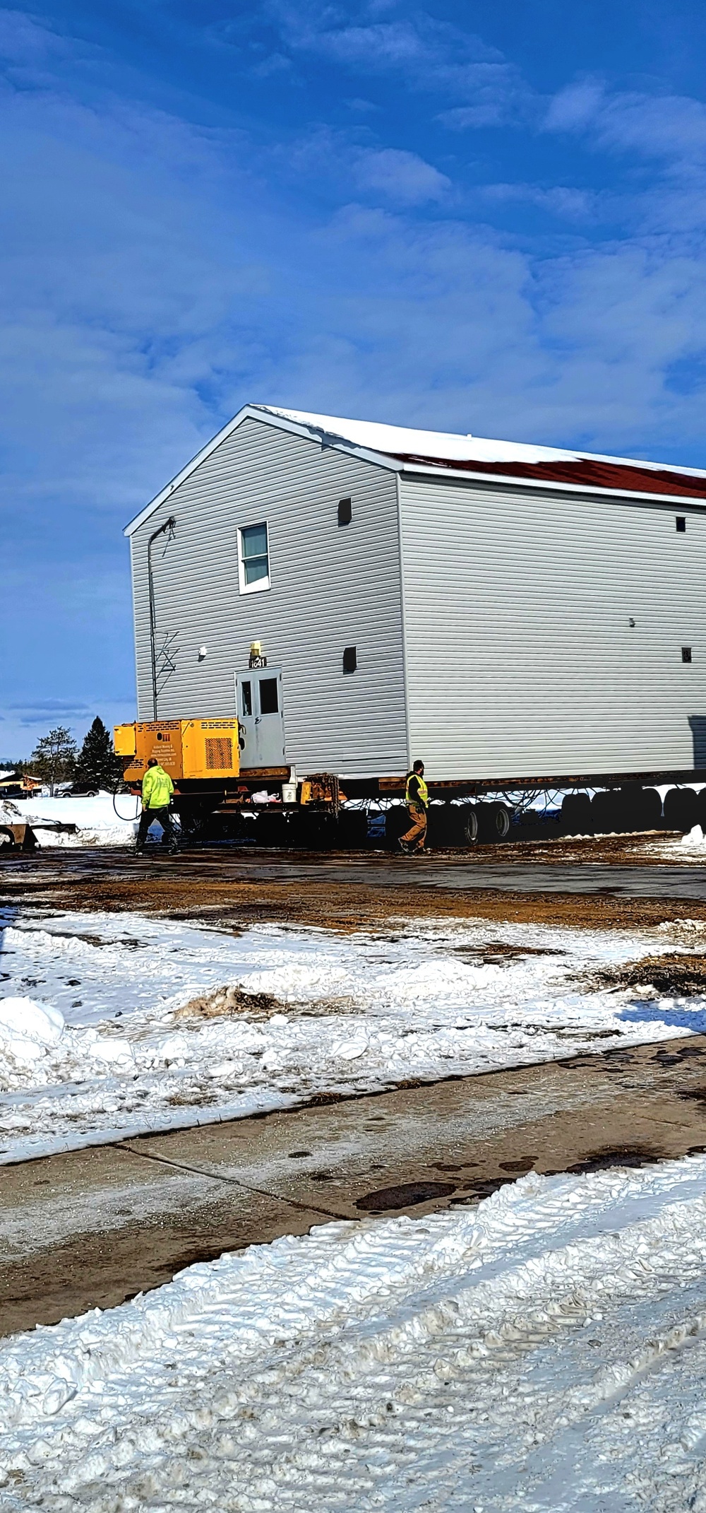 Contractors prepare World War II-era barracks buildings to be moved at Fort McCoy