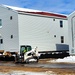 Contractors prepare World War II-era barracks buildings to be moved at Fort McCoy