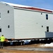 Contractors prepare World War II-era barracks buildings to be moved at Fort McCoy