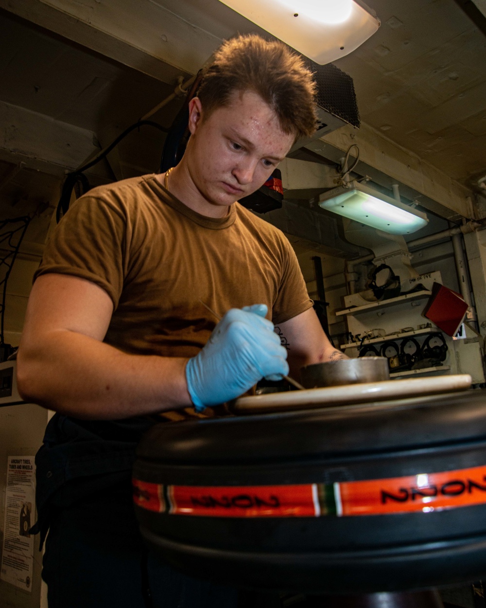 Sailor Assembles An Aircraft Tire