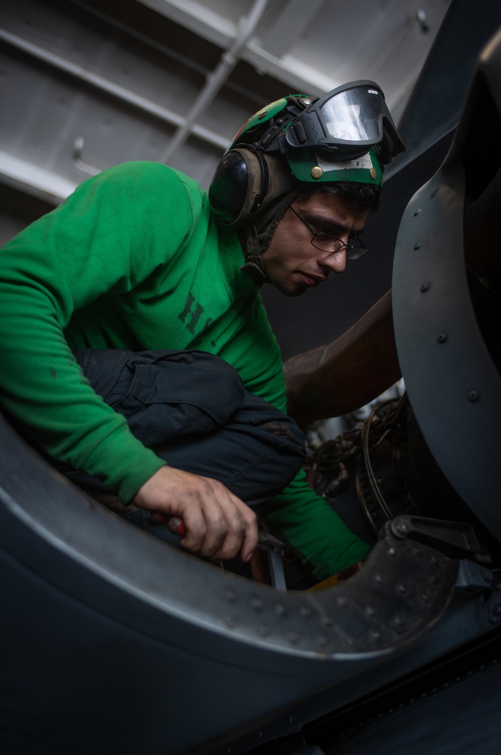 Sailor Conducts Routine Maintenance On Aircraft