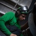 Sailor Conducts Routine Maintenance On Aircraft