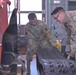 Vehicle Maintenance crew lifting a track for a compact track loader