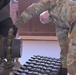 Airman Skyler Boucher changes a track on a compact track loader