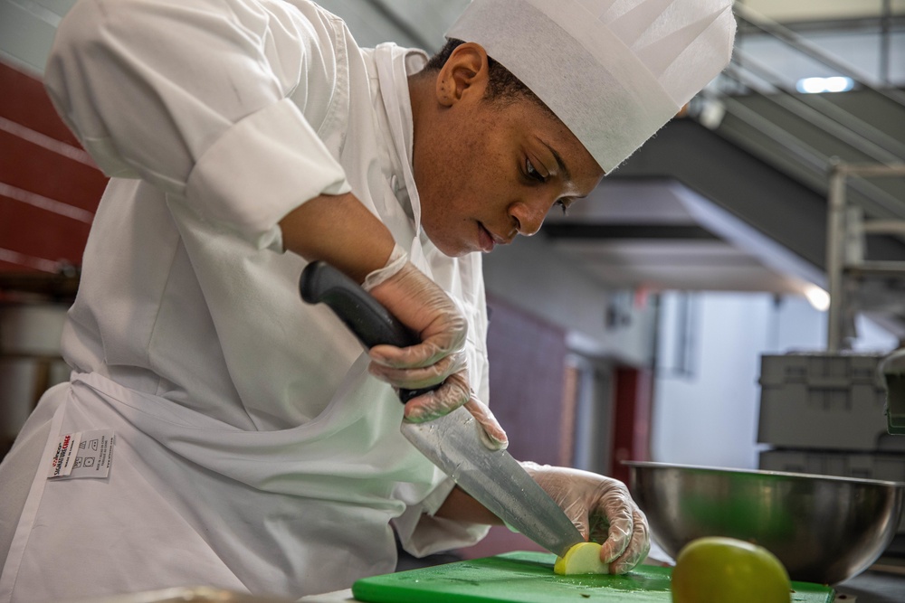 Spc Jacquay Clark slices an apple