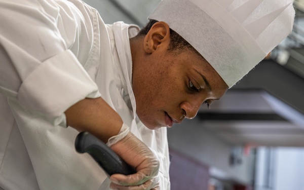 Spc Jacquay Clark slices an apple