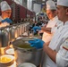 Sgt. 1st Class Jeffery Vaughan instructs Sgt. Jacob Hernandez and Sgt. Steven Philipps on serving their soup