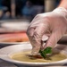 A Soldier puts the finishing touches on a soup