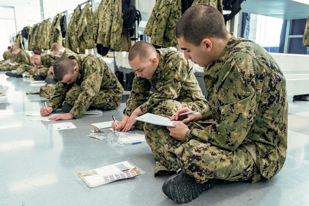 Recruits write letters during holiday routine at Recruit Training Command