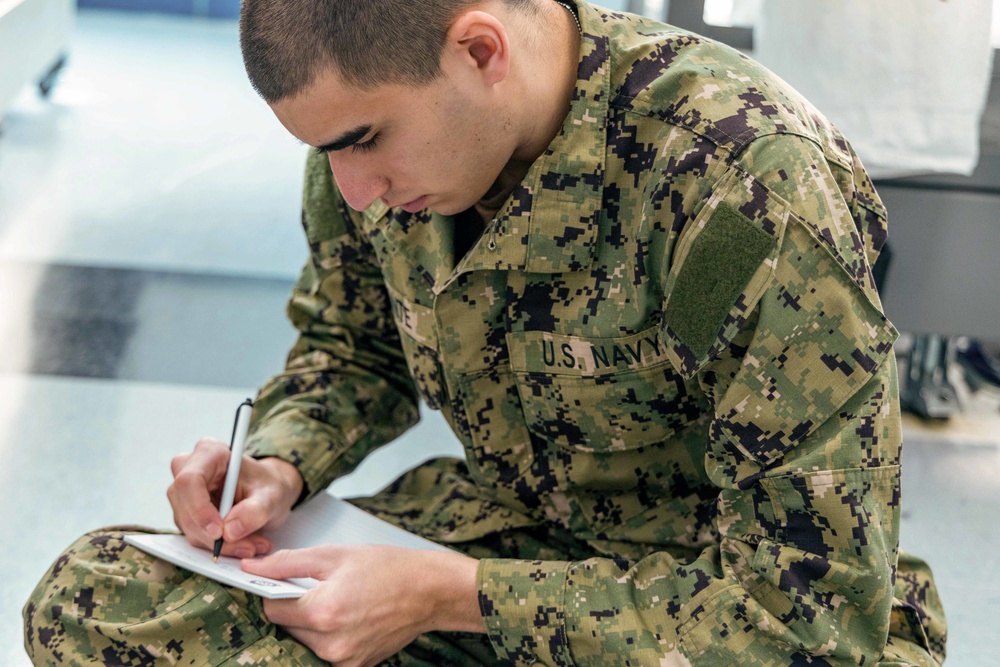 Recruits write letters during holiday routine at Recruit Training Command