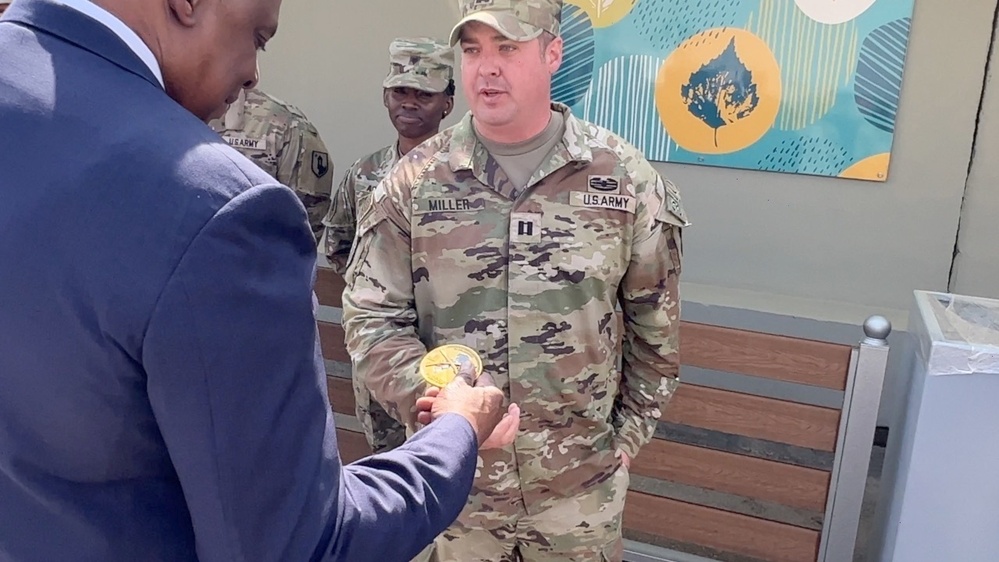 A coin is presented to the Secretary of Defense by 3rd SFAB