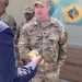 A coin is presented to the Secretary of Defense by 3rd SFAB