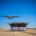 Marines of the Silent Drill Platoon, perform during the Blue Angels’ “Fat Albert” C-130J Super Hercules fly-over at Marine Corps Air Station, Yuma, Ariz.