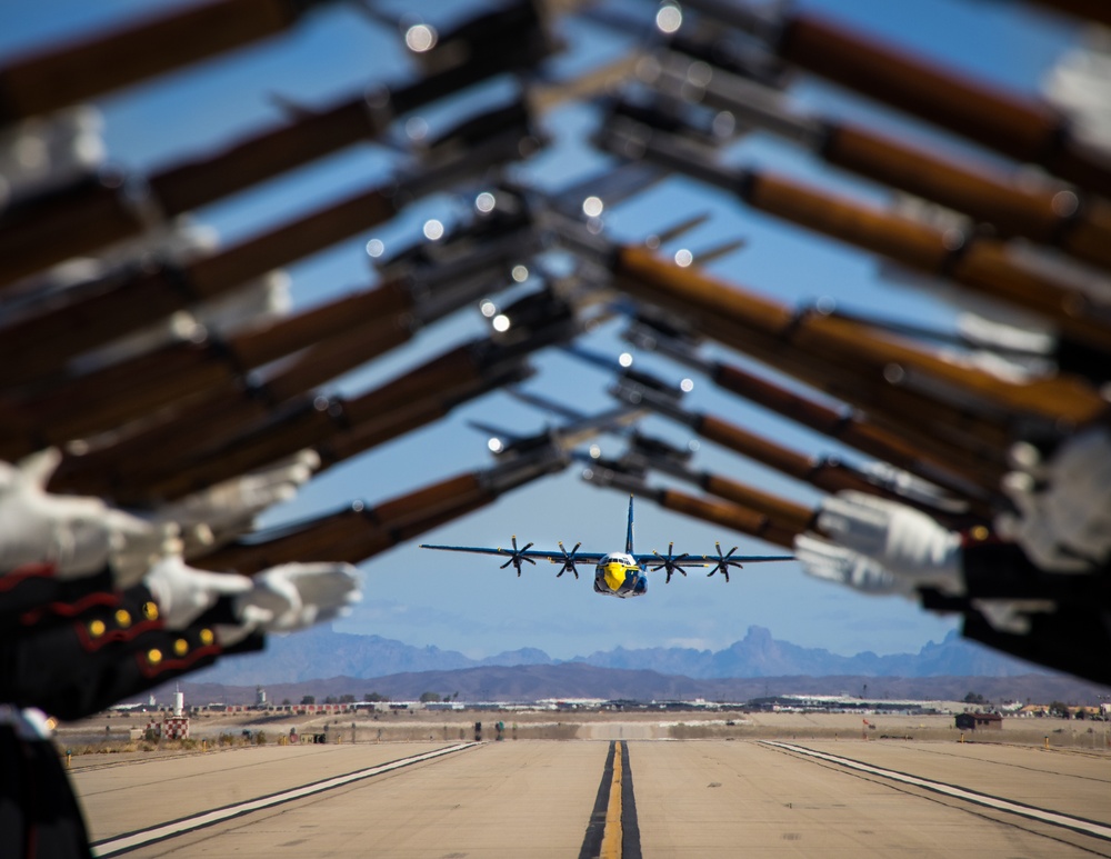 Marines of the Silent Drill Platoon, perform during the Blue Angels’ “Fat Albert” C-130J Super Hercules fly-over at Marine Corps Air Station, Yuma, Ariz.