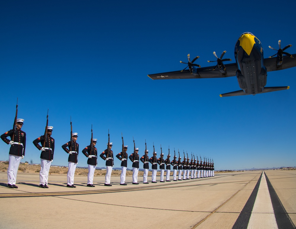 Marines of the Silent Drill Platoon, perform during the Blue Angels’ “Fat Albert” C-130J Super Hercules fly-over at Marine Corps Air Station, Yuma, Ariz.