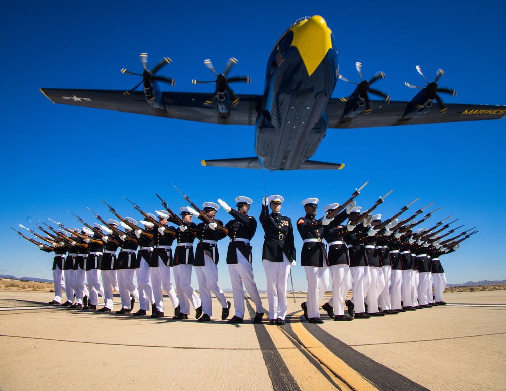 Marines of the Silent Drill Platoon, perform during the Blue Angels’ “Fat Albert” C-130J Super Hercules fly-over at Marine Corps Air Station, Yuma, Ariz.