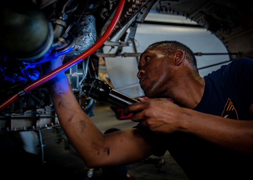 Sailor Inspects An Engine