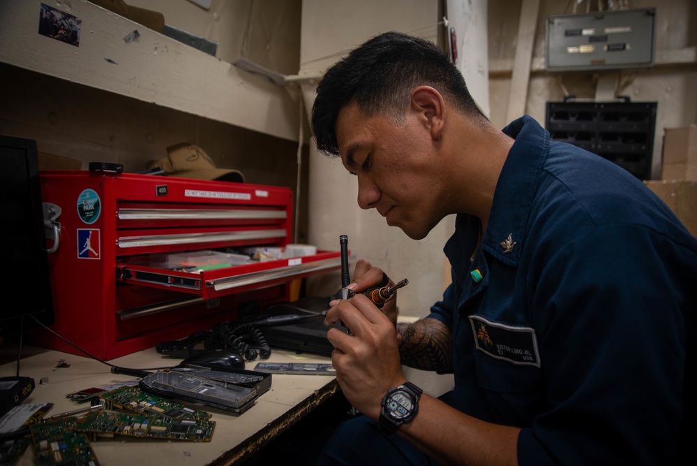 Sailor Conducts Maintenance On A Radio