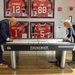 Retired Rear Adm. Sinclair Harris (left) and Public Affairs Officer, Navy Reserve Region Readiness and Mobilization Command, Great Lakes (NR REDCOM GL), Cmdr. Jeffrey Gray, play a game of air hockey