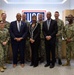 Retired Rear Adm. Sinclair Harris and retired Fleet Master Chief April Beldo-Lilley take a group photo with Sailors