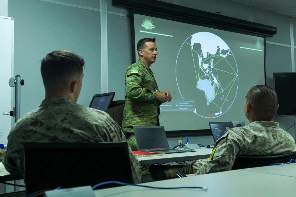 Australian Defense Force - Army Major speaks with U.S. Marines at Marine Corp Logistics Operations Group