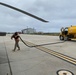 Petty Officer Third Class Luis Marcano-Schmilinsky carries the fuel hose during a routine fueling evolution on Naval Auxiliary Landing Field San Clemente Island.