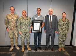 Lt. Raoni da Paixao e Silva, Brazilian Navy, accompanied by his leadership, celebrate his recent awards.
