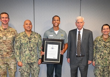 Lt. Raoni da Paixao e Silva, Brazilian Navy, accompanied by his leadership, celebrate his recent awards.