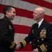 Capt. Raymond Barnes congratulates Cmdr. Matthew Starr
