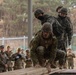 U.S. Marines with 3rd Maintenance Battalion and Republic of Korea Marines maneuver obstacle courses together during Korean Marine Exercise Program