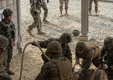U.S. Marines with 3rd Maintenance Battalion and Republic of Korea Marines maneuver obstacle courses together during Korean Marine Exercise Program
