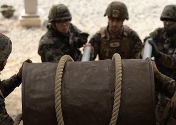 U.S. Marines with 3rd Maintenance Battalion and Republic of Korea Marines maneuver obstacle courses together during Korean Marine Exercise Program
