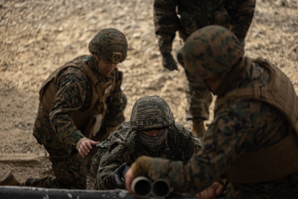 U.S. Marines with 3rd Maintenance Battalion and Republic of Korea Marines maneuver obstacle courses together during Korean Marine Exercise Program