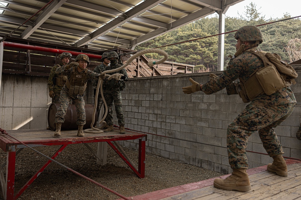 U.S. Marines with 3rd Maintenance Battalion and Republic of Korea Marines maneuver obstacle courses together during Korean Marine Exercise Program