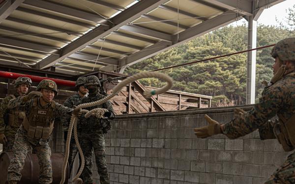 U.S. Marines with 3rd Maintenance Battalion and Republic of Korea Marines maneuver obstacle courses together during Korean Marine Exercise Program
