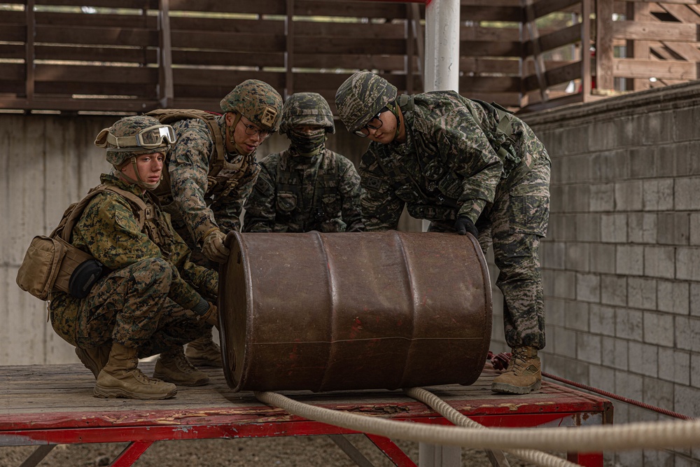 U.S. Marines with 3rd Maintenance Battalion and Republic of Korea Marines maneuver obstacle courses together during Korean Marine Exercise Program