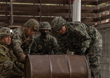 U.S. Marines with 3rd Maintenance Battalion and Republic of Korea Marines maneuver obstacle courses together during Korean Marine Exercise Program