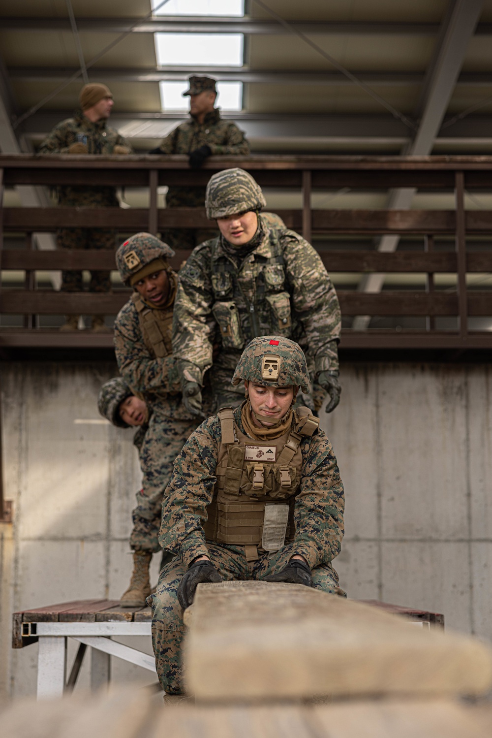 U.S. Marines with 3rd Maintenance Battalion and Republic of Korea Marines maneuver obstacle courses together during Korean Marine Exercise Program