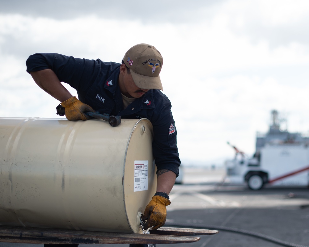 Sailor refills hydraulic fluid aboard USS Carl Vinson (CVN70)
