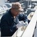 Sailor paints aboard USS Carl Vinson (CVN70)