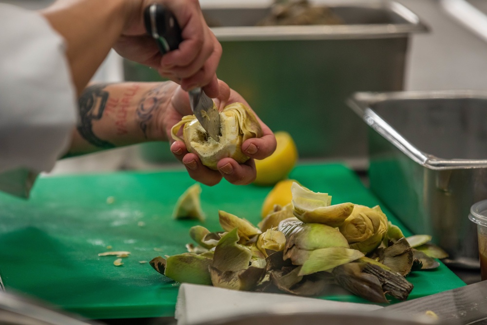 Warrant Officer 1 Daniella Blanco cuts an artichoke